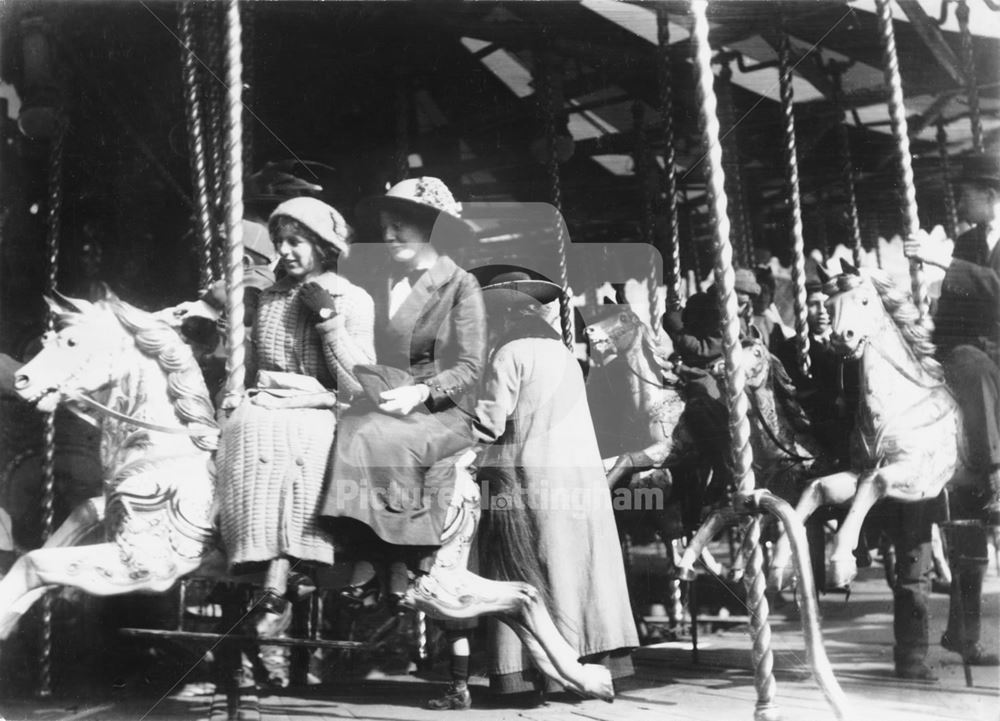 Goose Fair, Market Place, Women on a roundabout's galloping horses 1908