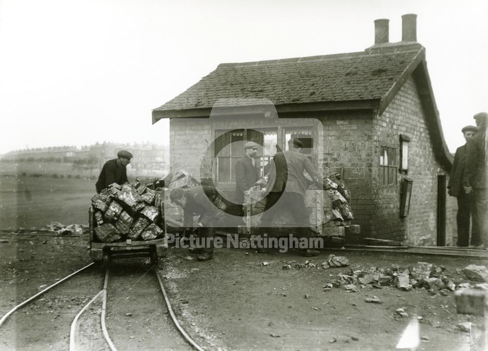 Radford Colliery. Miners manouvering wagons of coal near the pit-top.