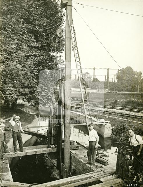 Culvert and bridge pier building on the River Leen during the