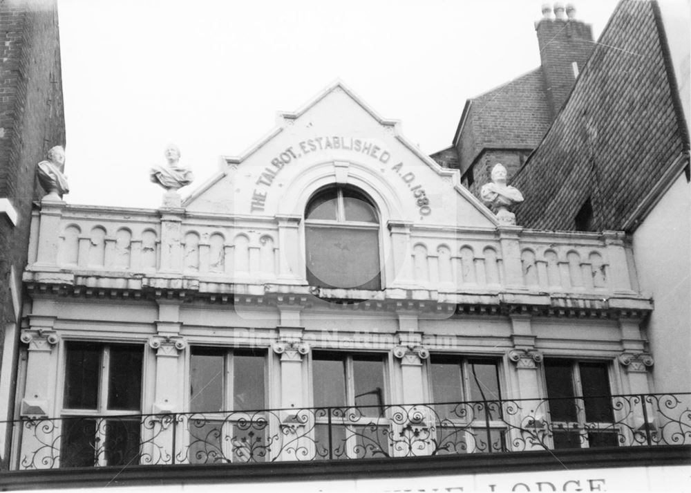 The Talbot Inn (Yates' Wine Lodge) - architectural detail of gable end with busts