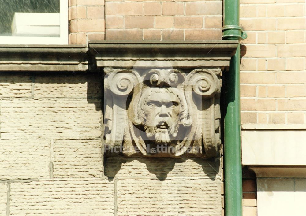 Detail of a carving on a warehouse facade