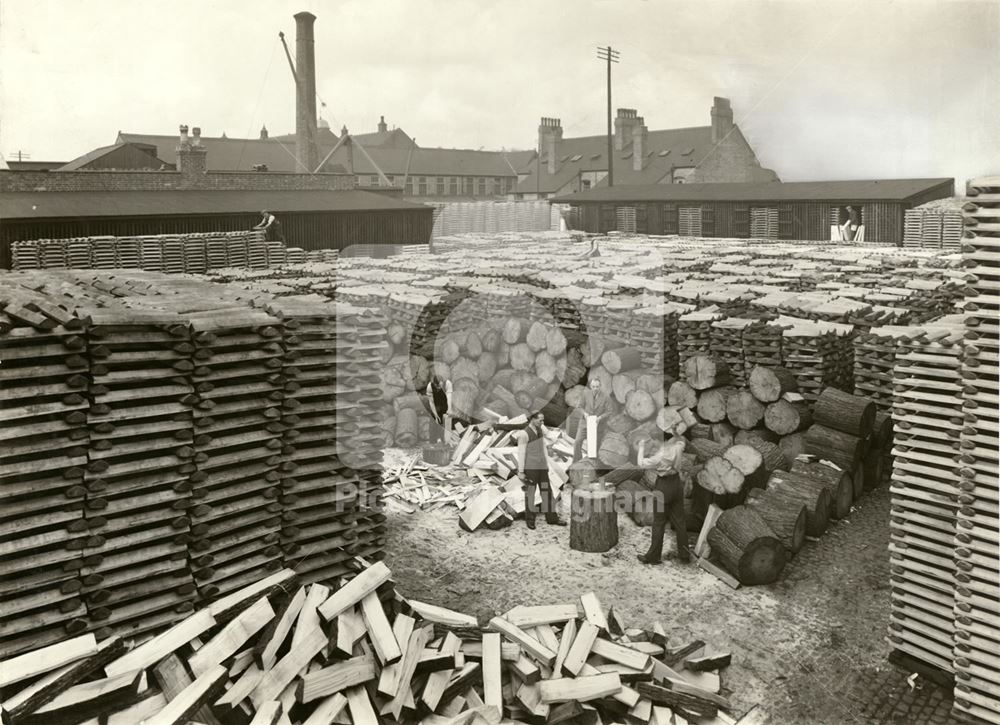 Log splitting in the timber yard of Ashworth Kirk and Co Ltd