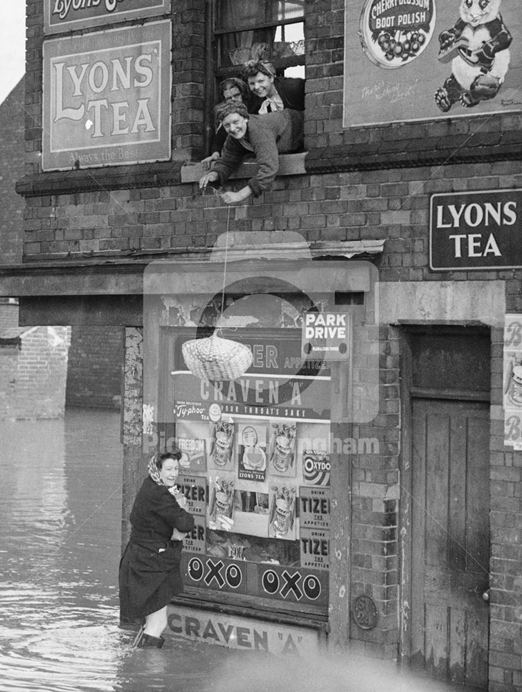 Women trapped above a shop during flooding, The Meadows, Nottingham, 1947