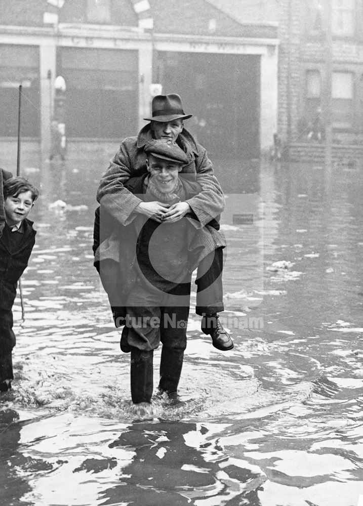 Man carrying another man during the 1947 floods of the River Leen, Bulwell, Nottingham 1947