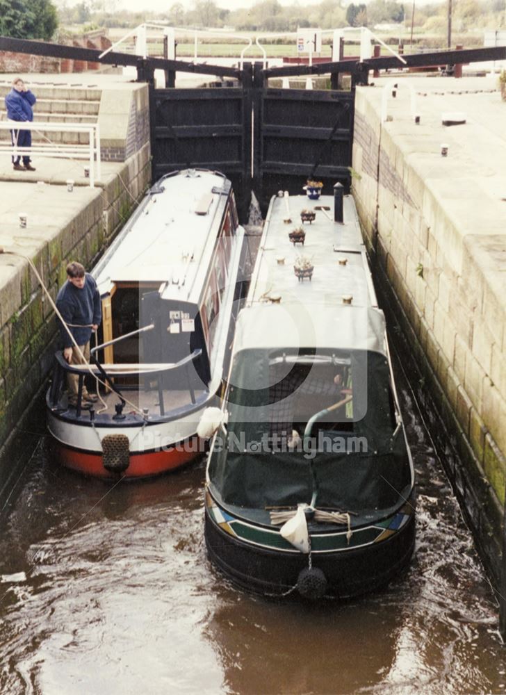 Narrowboats passing through Beeston Canal Lock at the junction with the River Trent