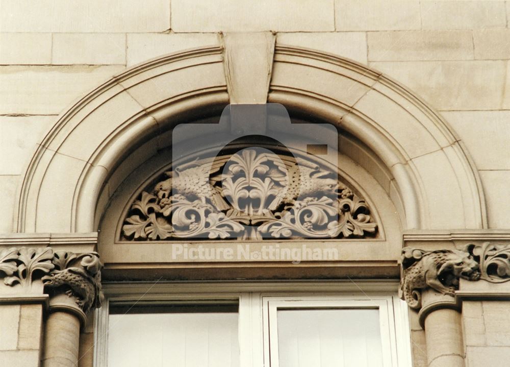 Sculpture in the tympanum above the window of the former Water Dept. Offices