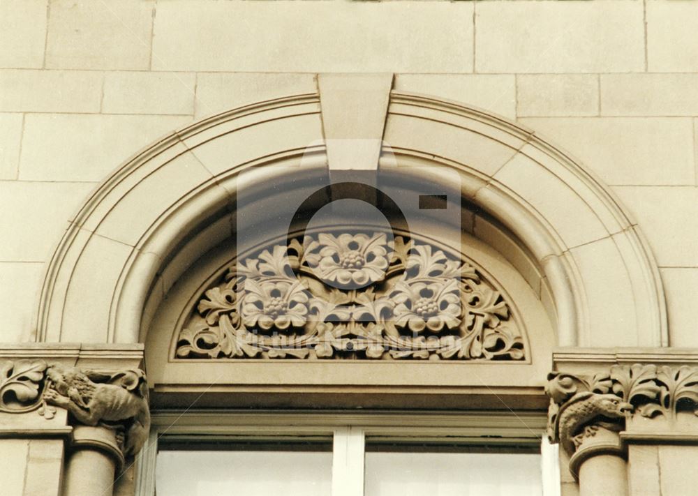 Sculpture in the tympanum above the window of the former Water Dept. Offices