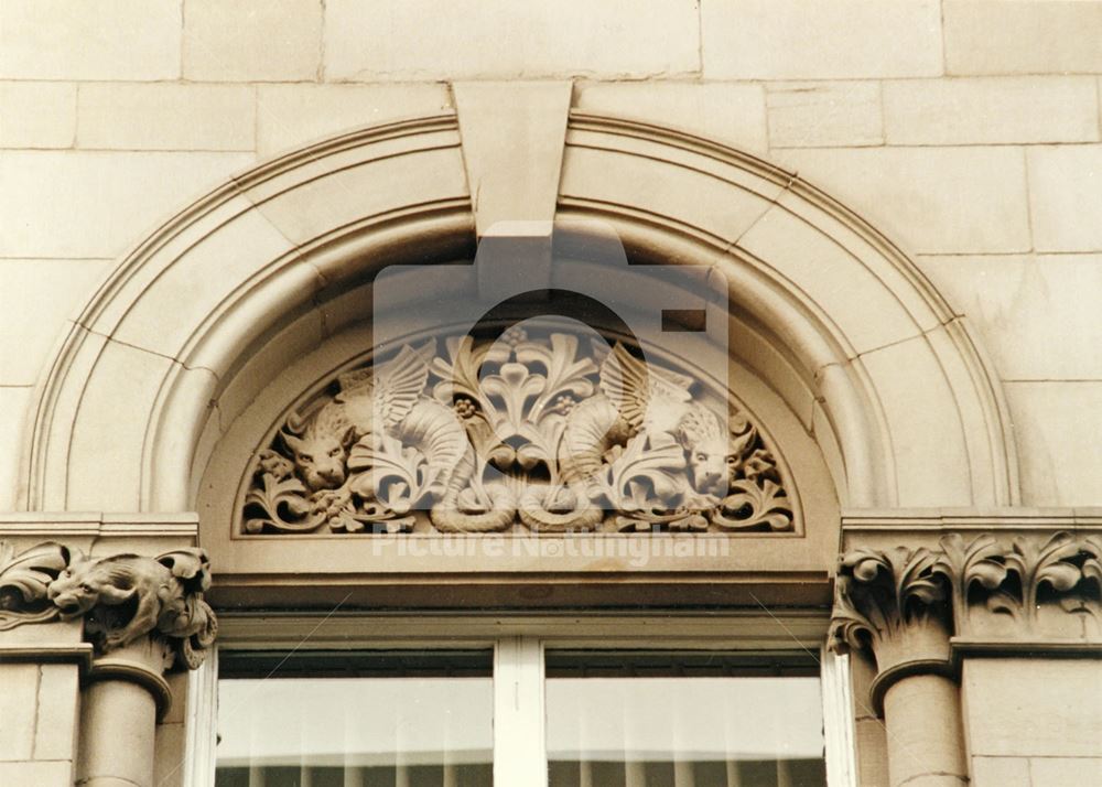 Sculpture in the tympanum above the window of the former Water Dept. Offices