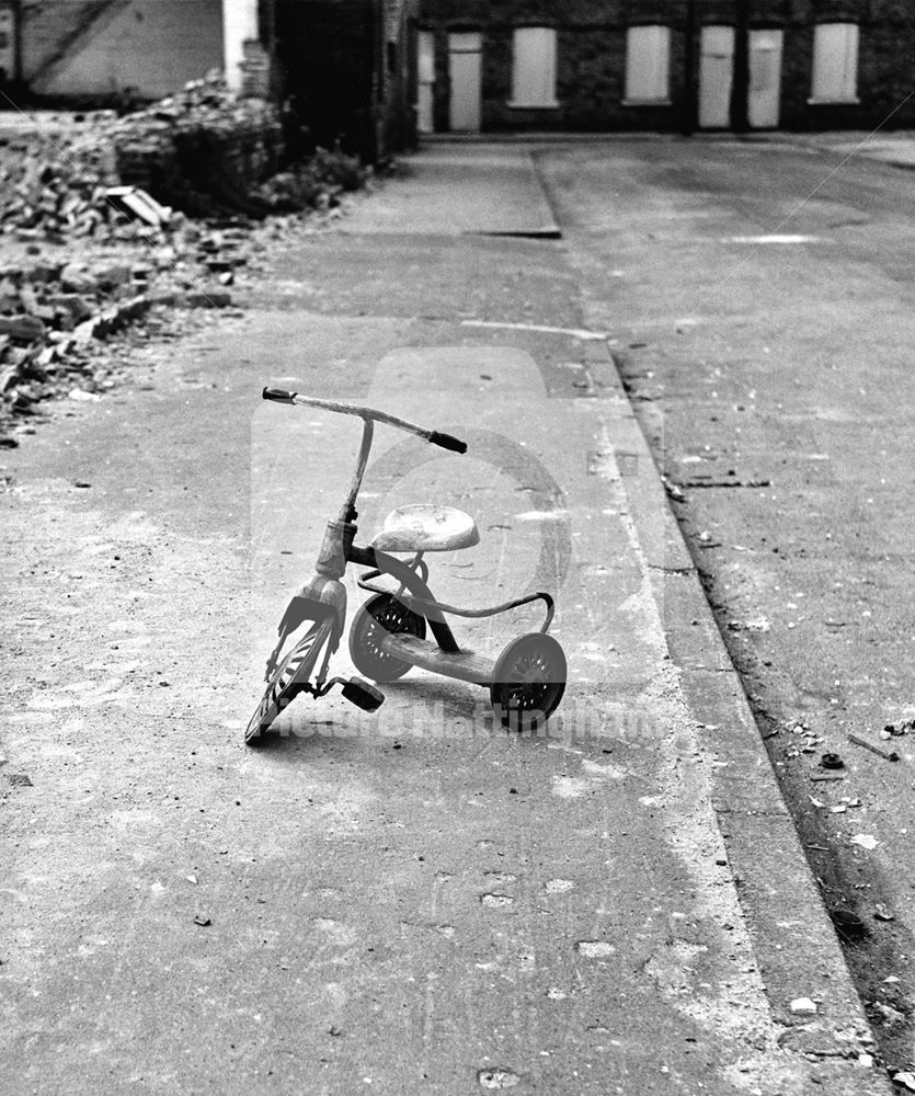 Child's tri-cycle (with only 1 pedal!) left behind during demolition of The Meadows