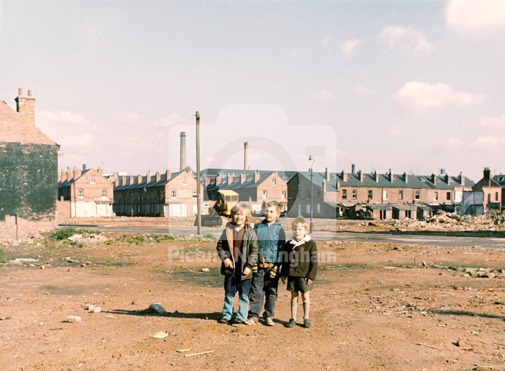 Three unidentified boys on the cleared land looking towards Lammas Street