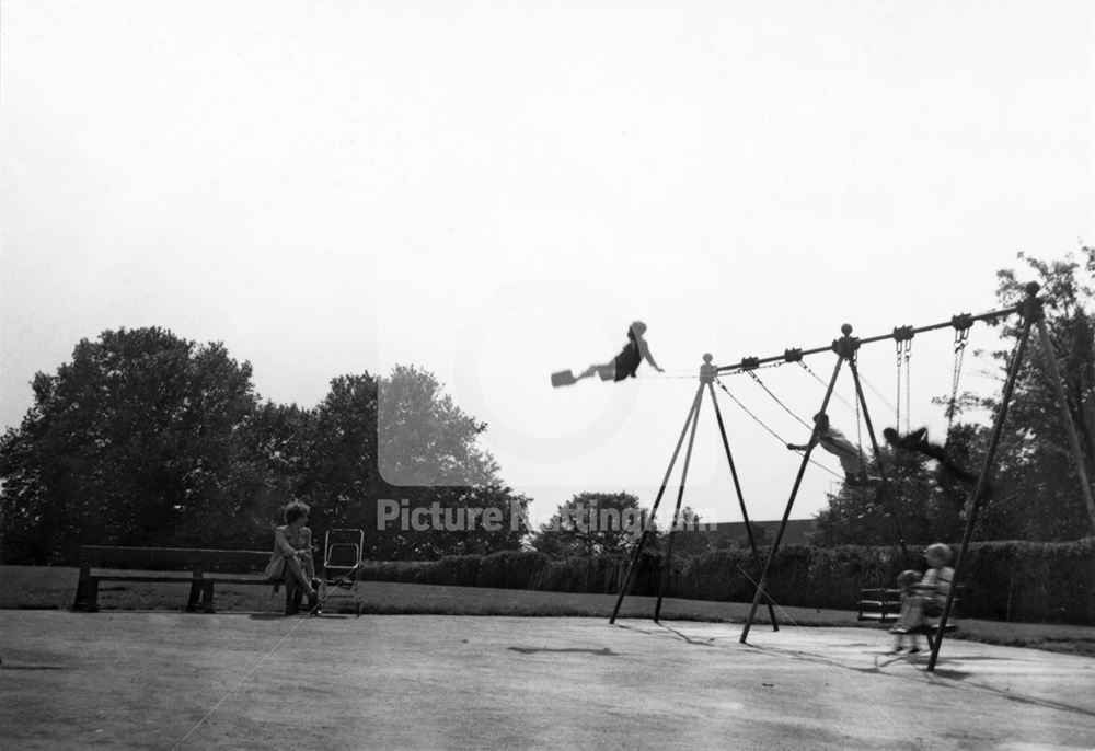 Children playing on the swings of the recreation ground, Ashburnham Avenue