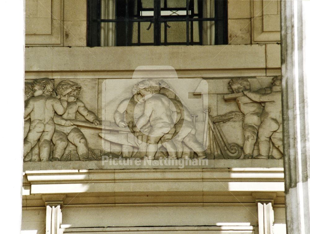 Council House - architectural detail of the 'trades' frieze behind the front columns - 'Iron working