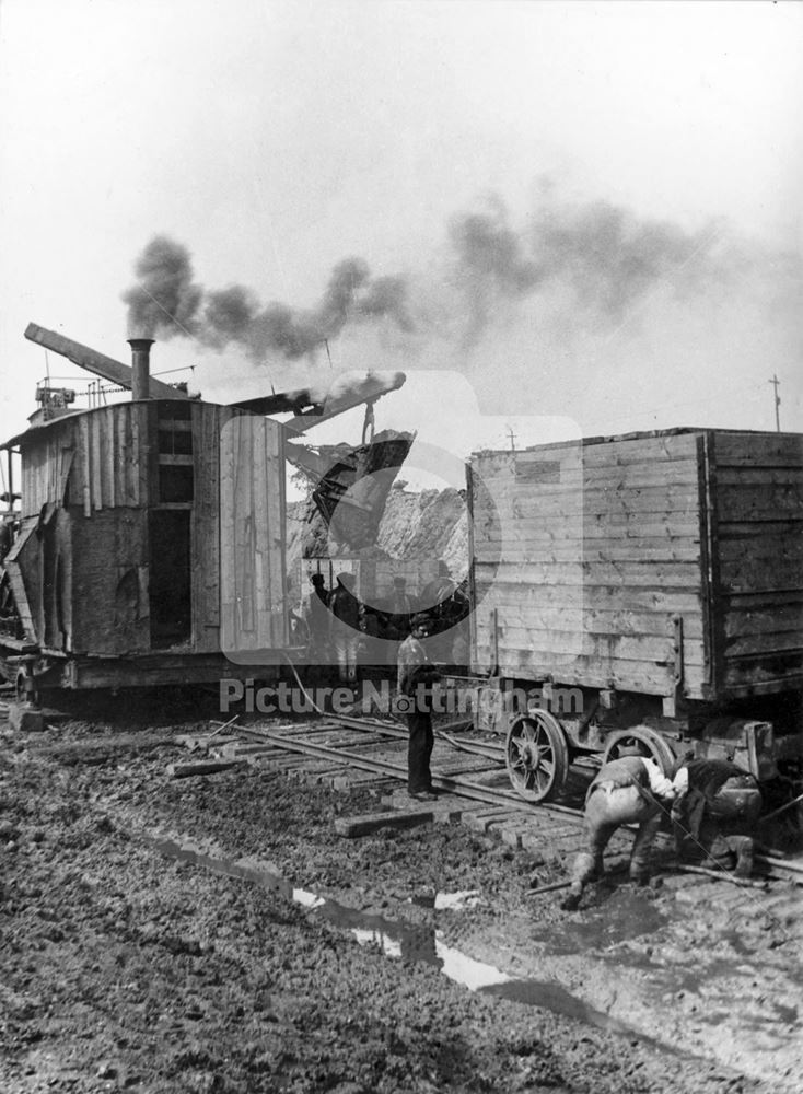 Victoria Station, during construction - a steam shovel loading earth into wagons