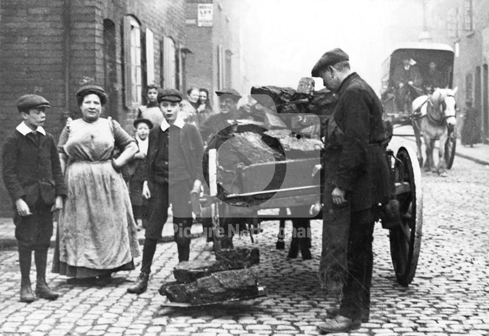 Weighing coal on the back of a cart