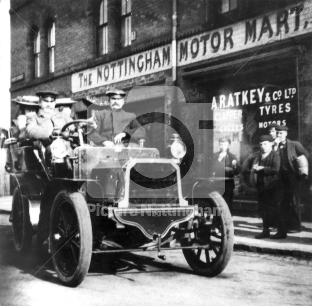 Motor Car and passengers outside A R Atkey's Garage