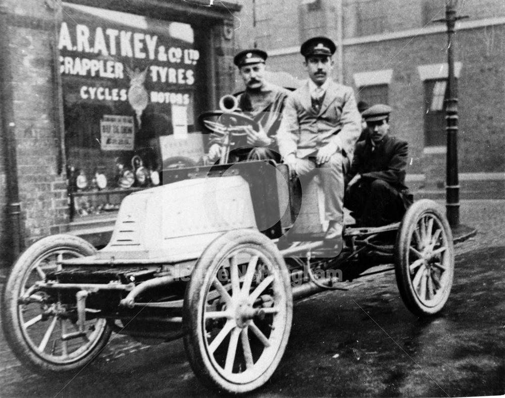 Motor Car (Renault ?)and passengers outside A R Atkey's Garage