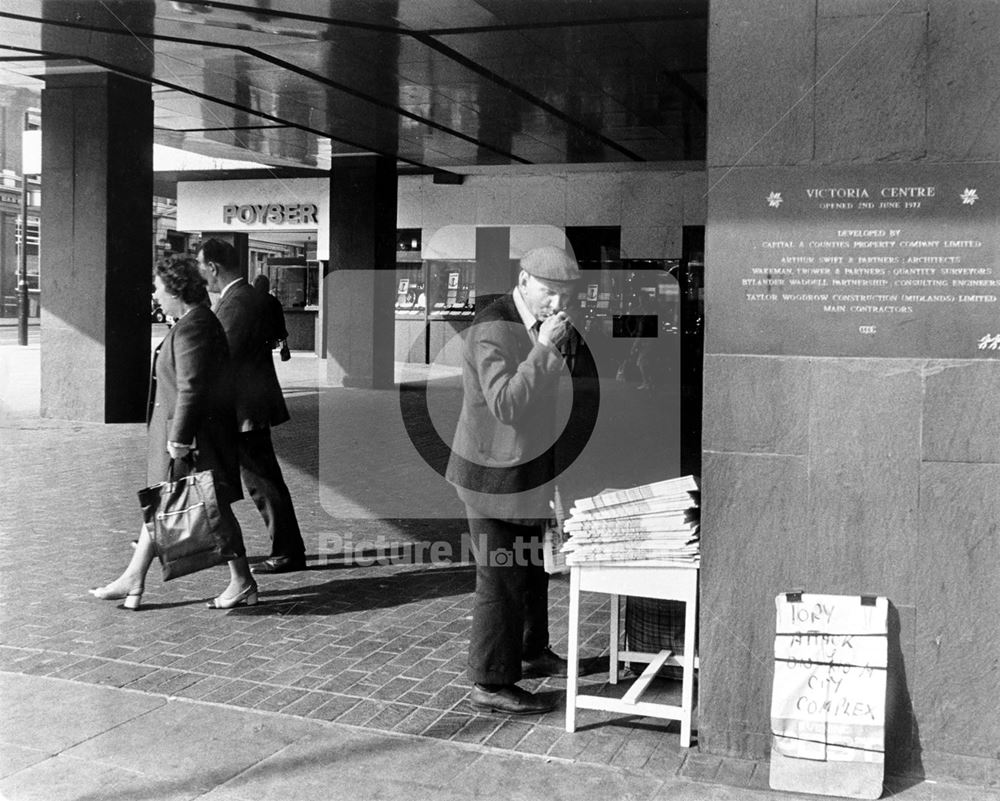 Newspaper seller by the entrance to Victoria Centre