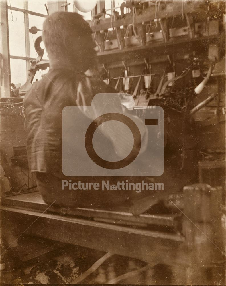 Interior showing a Framework-knitter or Stockinger working at his machine