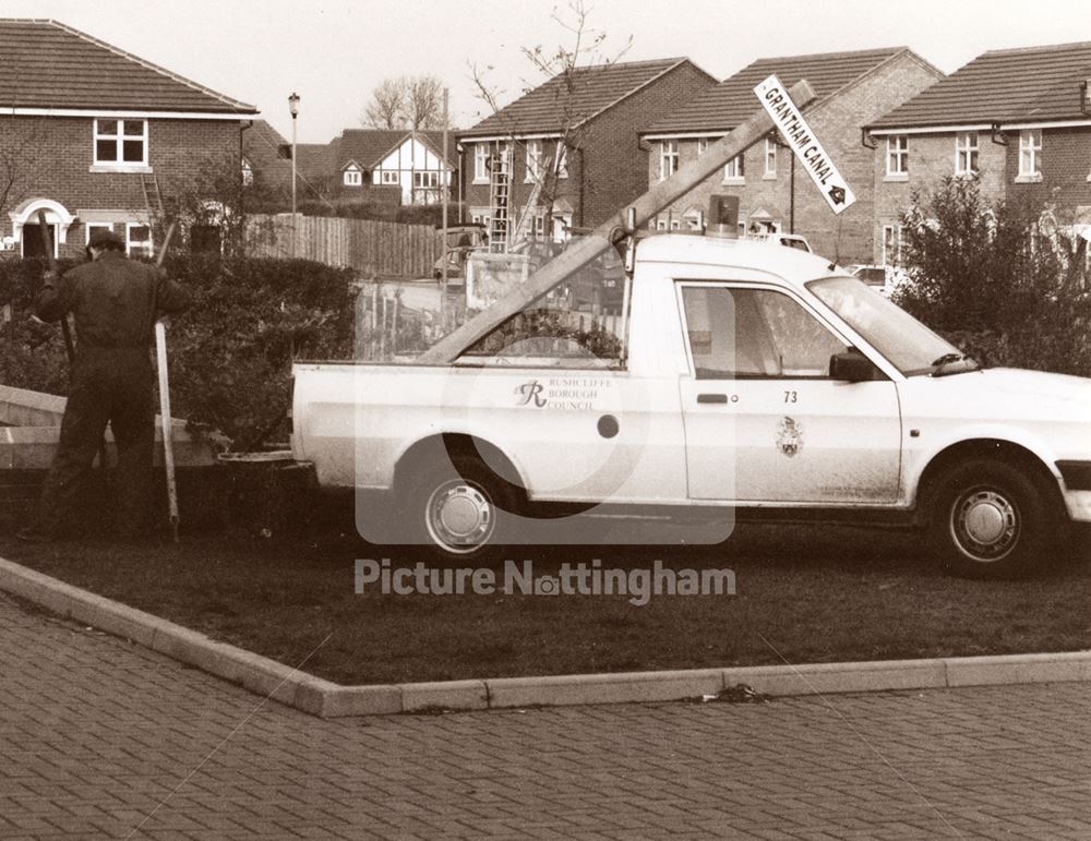 Erecting signpost 'Grantham Canal' at Safeway Supermarket, Gamston