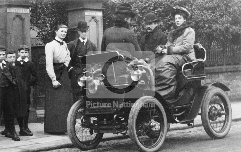 The Lambert family in an early car ( a De Dion Voiturette) beside the gates to Ellesmere House