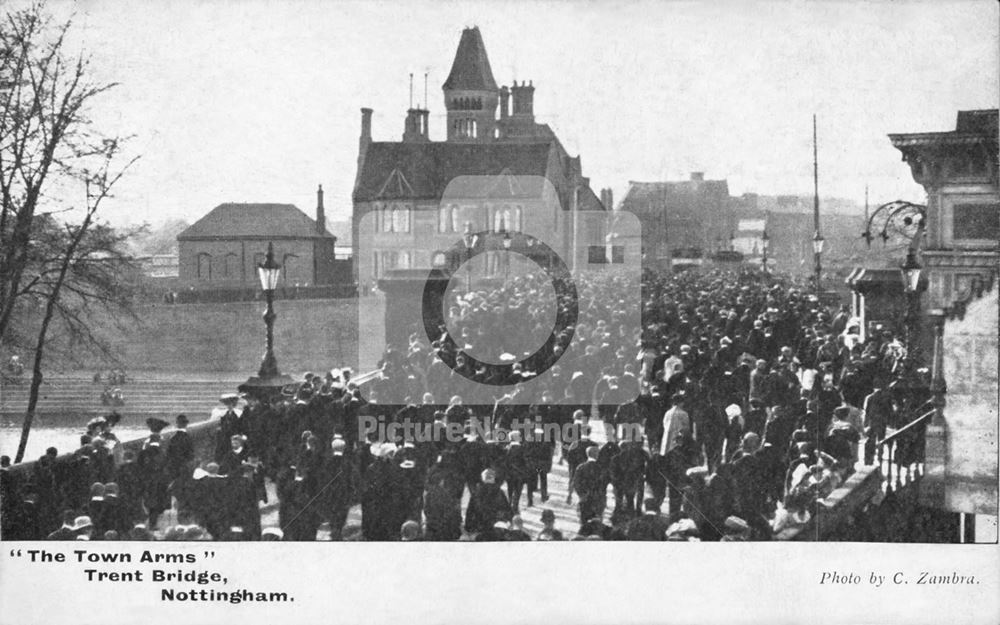 Crowds cross Trent Bridge in front of The Town Arms Public House, c 1900